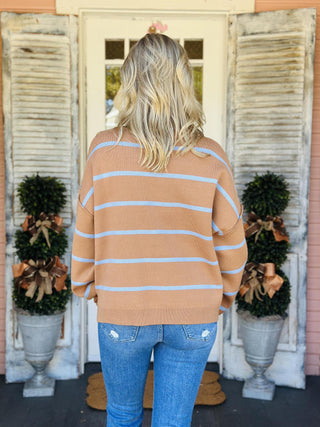 Woman wearing camel and blue striped turtleneck sweater

Cozy striped high-low turtleneck sweater in camel

Bonnie Sweater with blue horizontal stripes and relaxed fit

Brown and blue stripe fall sweater with ribbed hem

Drop shoulder camel stripe turtleneck sweater
