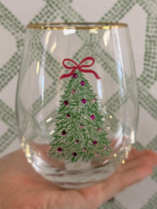 Rosy Woodlands Stemless Wine Glass featuring a Christmas tree with pink ornaments and a gold rim.