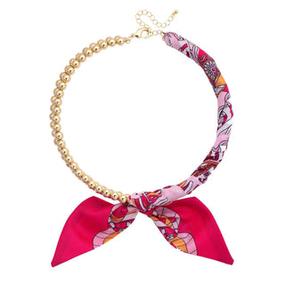 Cassie ball bead scarf necklace with pink patterned scarf bow

Gold ball bead necklace with fuchsia and orange scarf accent

Pink scarf bow ball bead statement necklace

Colorful ball bead scarf necklace with gold beads

Cassie scarf necklace with pink, orange, and white print