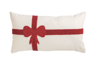 Lumbar Christmas Bow Beaded Pillow featuring a red beaded gift bow design on a cream cotton pillow with canvas backing, 12" x 22".
