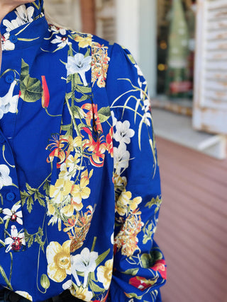 Elowyn Top with navy floral print and ruffle mock neck

Navy blue floral long sleeve blouse with ruffle collar

Elowyn Top floral blouse with smocked cuffs and high neckline

Romantic navy floral top with soft ruffle details

Lightweight floral blouse with mock neck and gathered sleeves