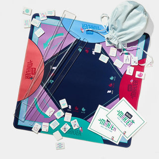 Mini Mahjer Complete Game OG Edition with colorful mahjong tiles, acrylic racks, neoprene playing mat, instruction cards, and storage bag.