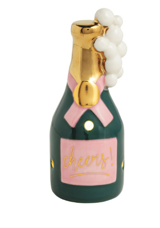 Hand-painted ceramic Champagne Light-Up Sitter featuring a champagne bottle with gold foil, pink label, "Cheers!" lettering, bubbly accents, and LED lights.