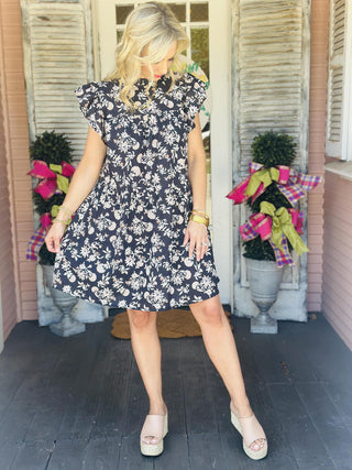 Woman wearing floral ruffle neck dress with flutter sleeves

Gabriela cotton cambric dress with short flutter sleeves and fall floral print