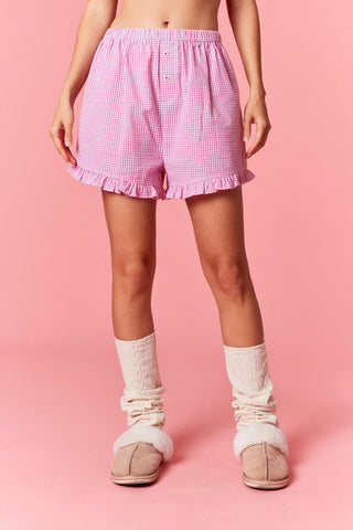 Raya pink gingham shorts with red “Cheers” embroidery on back

Pink ruffled gingham lounge shorts with embroidered lettering

Raya pink check shorts with ruffle hem and holiday detail

Women’s pink gingham pajama shorts with red script “Cheers”

Cozy pink gingham ruffle sleep shorts with festive embroidery