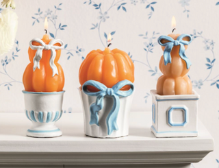 Pumpkin Topiary Candles featuring figural stacked pumpkins with elegant blue bows, wrapped in cello for fall decorating and gifting.