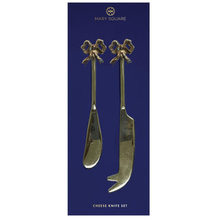 Set of two gold holiday cheese knives with festive handles

Gold cheese knife set with wreath and bow handle designs

Elegant holiday cheese knives on navy backing card

Two-piece gold cheese knife set for entertaining

Mary Square holiday cheese knife set with giftable design
