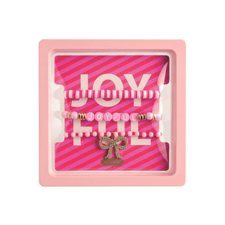 Pink Joyful holiday bracelet set with bow charm in gift box

Three pink and gold beaded stretch bracelets with holiday theme

