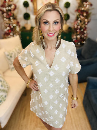 Beige short sleeve dress with textured floral details

Neutral mini dress with white embroidered pattern

Short sleeve beige shift dress with 3D floral accents