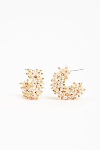 Mini gold-plated hoop earrings with blush faux pearls and gold bead accents

Small Talulah hoop earrings in white faux pearls with gold-plated brass

Mini statement hoop earrings with clustered faux pearls and gold detailing