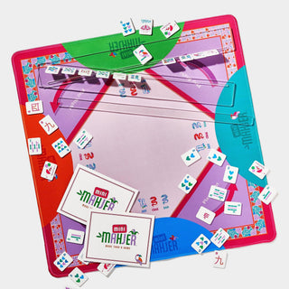 Mini Mahjer Complete Game Rackin Rosie Edition with colorful mahjong tiles, acrylic racks, neoprene playing mat, instruction cards, and drawstring storage bag.