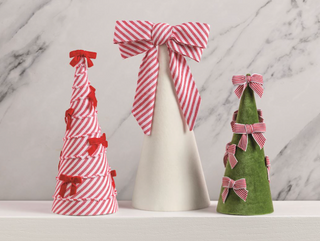 Set of three decorative Christmas tree sitters with striped bows

Velvet and cotton tabletop Christmas trees with red and white bows

Bow tree holiday decor in green, white, and striped cone designs