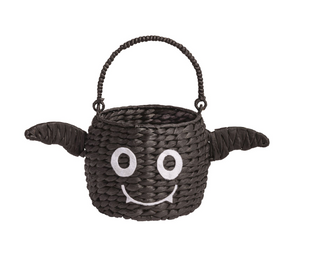 Woven seagrass Halloween treat baskets featuring pumpkin, ghost, and pink jack-o'-lantern designs with felt facial details and decorative ribbon bows.