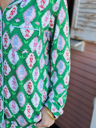 Charlotte Cavalry Christmas Pajama Set with green lattice holiday print

Women’s Christmas pajama set in green, pink, and red Cavalry print

Holiday pajama set with collared button top and drawstring pants

Green festive pajama set with geometric Christmas pattern

Charlotte Cavalry Pajama Set with pockets and classic button top