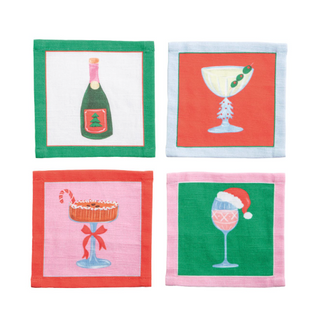 Set of four cotton holiday cocktail napkins featuring festive Christmas drink illustrations including champagne, martini, cocoa, and dessert cocktails.