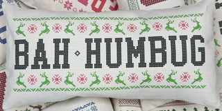 Bah Humbug pillow with green and red cross-stitch pattern on beige fabric

Funny Christmas pillow with Bah Humbug text and reindeer design

Rectangular beige pillow featuring stitched Bah Humbug lettering

Holiday pillow with green reindeer and red snowflake accents

Humorous holiday throw pillow with cross-stitch Bah Humbug design