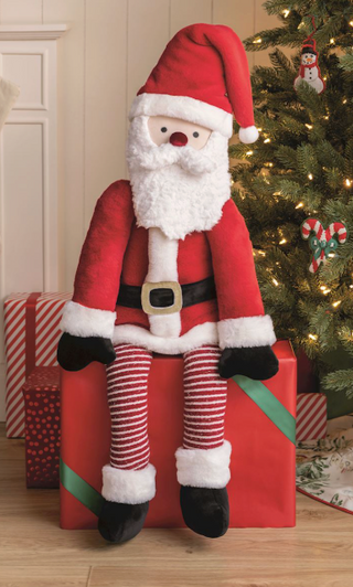 Large Santa Claus plush featuring soft faux fur, velvet suit, sweater knit details, striped legs, and dangling feet for Christmas decorating.