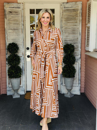 Uncle Frank Carmen Shirt Dress with geometric print, button-front design, long sleeves, pockets, and optional tie belt.
