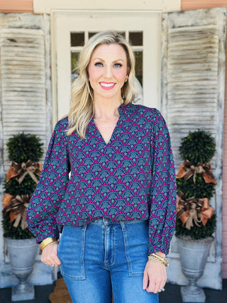 "Aria Second Glance Pink Top with geometric floral print in pink, teal, and navy"

"Women’s patterned blouse with V-neckline and long sleeves"

"Aria Second Glance Pink Top featuring bold pink and teal print with relaxed silhouette"