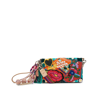 Consuela Dezi Uptown Crossbody with colorful floral embroidery, turquoise pattern, and adjustable woven crossbody strap