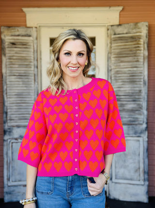 Pink and red heart print short sleeve sweater with heart buttons

Ivy Jane pink sweater with red heart pattern and button front

Heart felt pink sweater top with short sleeves and ribbed hem

Valentine heart print sweater top by Ivy Jane

Pink knit heart sweater with red hearts and decorative buttons