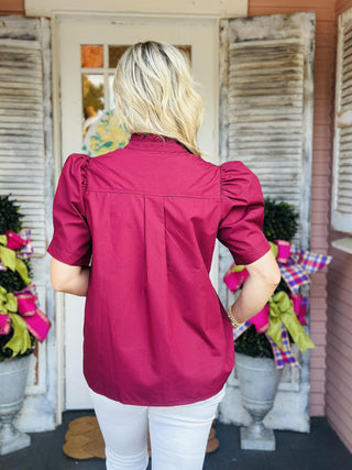 Burgundy puff sleeve blouse with ruffled collar and button-down front