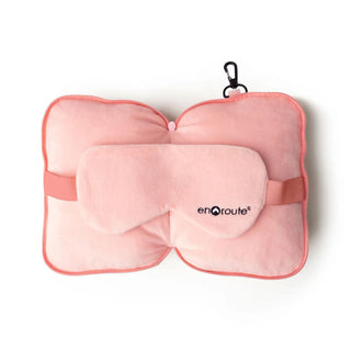 Pink travel pillow with matching eye mask and clip, featuring soft fabric and compact design.
