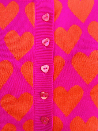 Pink and red heart print short sleeve sweater with heart buttons

Ivy Jane pink sweater with red heart pattern and button front

Heart felt pink sweater top with short sleeves and ribbed hem

Valentine heart print sweater top by Ivy Jane

Pink knit heart sweater with red hearts and decorative buttons