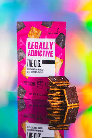 Legally Addictive The O.G. cookies bag with chocolate toffee crackers

Legally Addictive Peppermint Crunch holiday cookies bag with toffee and chocolate

Legally Addictive Surprise Party cookies with sprinkles on colorful packaging

Legally Addictive Everything cookies bag with toffee chocolate and seasoning

Legally Addictive Salted Gingerbread cookies bag with chocolate graham crackers