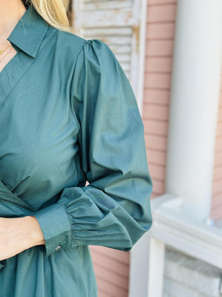 "Laney Dress in sea green with V-neckline, waist tie belt, long sleeves, and tiered hem"

"Sea green midi dress with adjustable waist belt, V-neck, and side pockets – Laney Dress"

"Women’s long sleeve wrap-style dress in sea green with tie waist and pockets"
