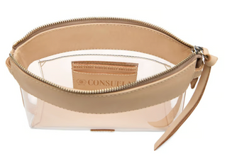 Consuela Diego Clear Midtown Crossbody featuring a transparent body, natural leather trim, zip-top closure, and a colorful adjustable woven crossbody strap.