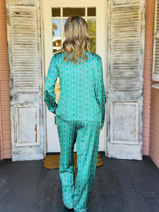 Green Charlotte In A Bow Christmas Pajama Set with festive bow print

Women’s green holiday pajama set with bow pattern and button top

Christmas pajama set with green satin finish and drawstring pants

Green festive sleep set with bow print and long sleeves

Charlotte In A Bow Pajama Set with classic button-up top