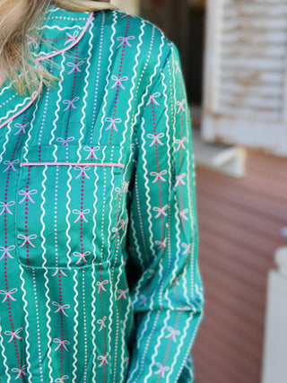 Green Charlotte In A Bow Christmas Pajama Set with festive bow print

Women’s green holiday pajama set with bow pattern and button top

Christmas pajama set with green satin finish and drawstring pants

Green festive sleep set with bow print and long sleeves

Charlotte In A Bow Pajama Set with classic button-up top