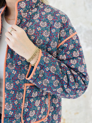 Meadow block print quilted jacket with peach piping and floral pattern

Woman wearing floral cotton quilted jacket with front pockets

Colorful block print jacket with contrast trim and oversized pockets