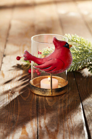 Glass tea light holder with red cardinal design and gold base on wooden table

Festive cardinal candle holder with glass votive and metal base

Holiday tea light holder featuring a red cardinal and gold accent stand


