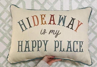 Cream pillow with multicolored “Hideaway Is My Happy Place” lettering.

Decorative Hideaway Texas pillow with colorful text and teal piping.

Rectangular accent pillow featuring “Hideaway Is My Happy Place” design.