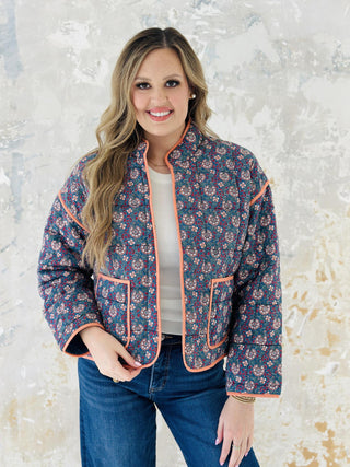 Meadow block print quilted jacket with peach piping and floral pattern

Woman wearing floral cotton quilted jacket with front pockets

Colorful block print jacket with contrast trim and oversized pockets