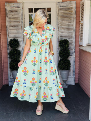 Sage green floral midi dress with flutter ruffle sleeves and ruched V-neck detail.