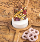 Hand-painted ceramic Charcuterie Light-Up Sitter featuring a charcuterie board with cheese, grapes, bread, salami, olives, and LED lights on a white display base.