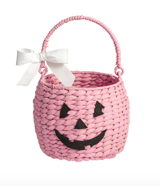 Woven seagrass Halloween treat baskets featuring pumpkin, ghost, and pink jack-o'-lantern designs with felt facial details and decorative ribbon bows.