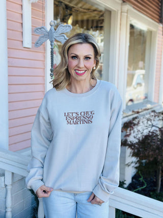 Let’s Chug Espresso Martinis crewneck sweatshirt in cream

Neutral crewneck with brown espresso martini graphic text

Cozy beige sweatshirt with Let’s Chug Espresso Martinis lettering

Trendy coffee-inspired crewneck in neutral cream color

Cream graphic sweatshirt with espresso martini slogan