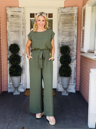 Dark green Ella Kate Jumpsuit featuring a sleeveless silhouette, elastic waist, front tie detail, and wide-leg woven design.