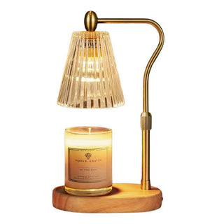 Candle Warmer Lamp with fluted amber glass shade, brushed gold metal frame, and wooden base designed to safely warm jar candles without an open flame.