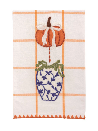 White cotton hand towel with an orange windowpane pattern, pumpkin and blue chinoiserie vase appliqué, embroidered details, and orange triangle embroidered hem.