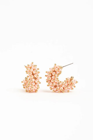 Mini gold-plated hoop earrings with blush faux pearls and gold bead accents

Small Talulah hoop earrings in white faux pearls with gold-plated brass

Mini statement hoop earrings with clustered faux pearls and gold detailing