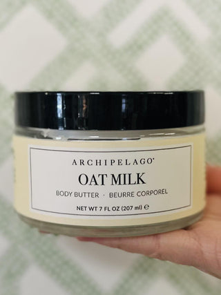 Archipelago Oat Milk body butter in glass jar with black lid