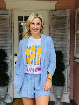 Ellie Blazer in chambray blue featuring a relaxed fit, ruched three-quarter sleeves, and an open front.