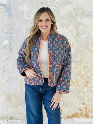 Meadow block print quilted jacket with peach piping and floral pattern

Woman wearing floral cotton quilted jacket with front pockets

Colorful block print jacket with contrast trim and oversized pockets