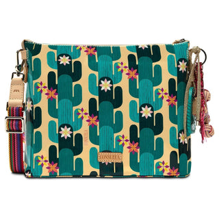 Consuela Dezi Downtown Crossbody with colorful floral embroidery, turquoise pattern, natural leather trim, and adjustable woven strap