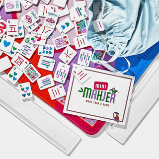 Mini Mahjer Complete Game Rackin Rosie Edition with colorful mahjong tiles, acrylic racks, neoprene playing mat, instruction cards, and drawstring storage bag.